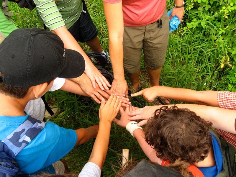 boys putting hands together in center